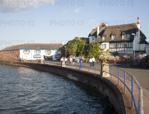 Thatched historic houses on the seafront at Paignton, Devon, England, UK