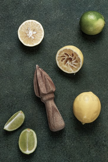 Wooden citrus reamer, manual lemon juicer, made of acacia wood, with citrus fruits on the table,