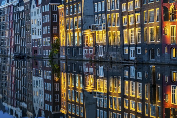 Canal houses on the Damrak, in the centre of the old town of Amsterdam, harbour, starting point of