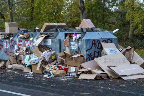Overfilled waste paper containers, despite the overcrowding, people have put their waste paper next