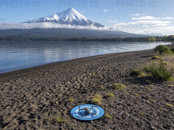 Drone on a landing pad at beach Playa Ensenada, lake Llanquihue, volcano Osorno, chilenean lake