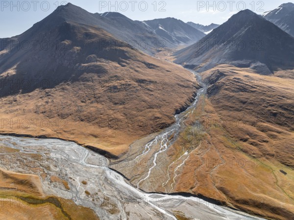 Aerial view, Burkhan mountain valley with meandering river, barren dramatic mountain landscape,