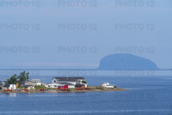 Headland with colourful houses in Frenchman's Cove, behind Weeball Island, also Guernsey Island,