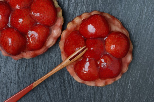Topped strawberry tarts with a fork