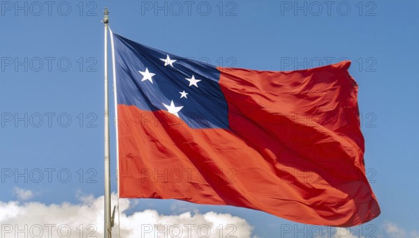 The flag of Samoa, fluttering in the wind, isolated against a blue sky