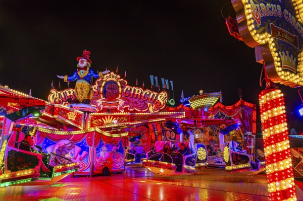 Illuminated round and elevated ride Circus Circus at standstill, night shot, Oktoberfest,