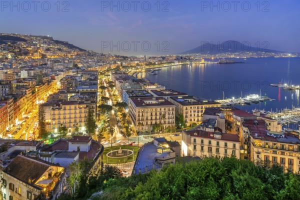 Western district of Mergellina by the sea with the Vomero and Mount Vesuvius 1281m at dusk, Naples,