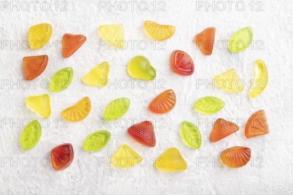 Various fruit jelly candies on gray concrete background. top view, flat lay, close up