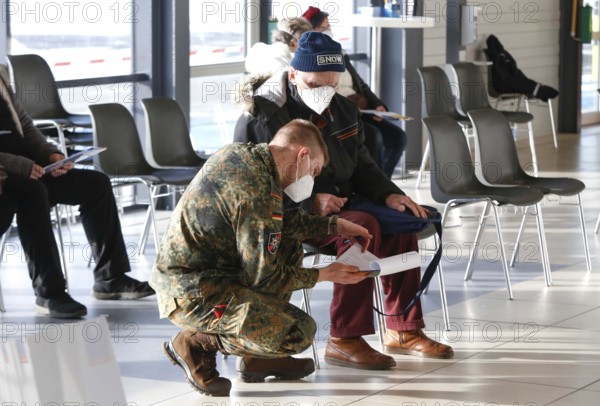 Vaccinees and a soldier of the German Armed Forces in the vaccination centre in Terminal 5 of BER