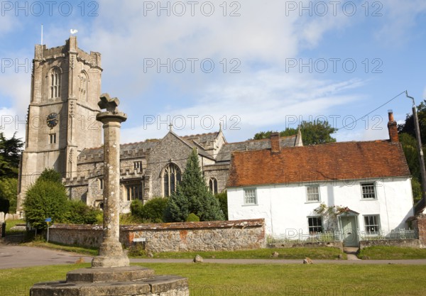 Church of St Michael and butter cross on the village green in Aldbourne, Wiltshire, England, United