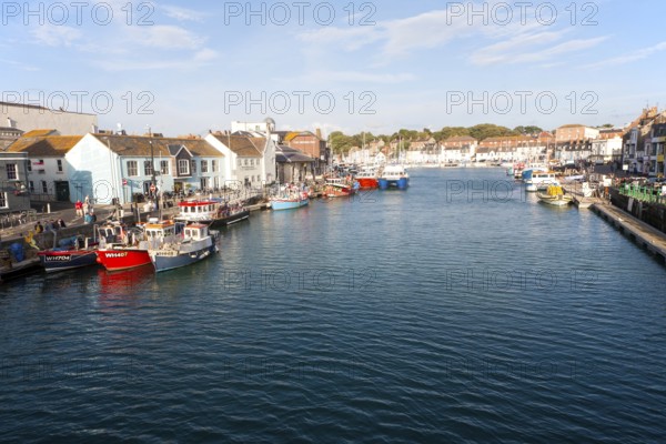 Colourful fishing boats in the harbour at Weymouth, Dorset, England, UK