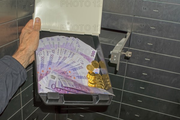 Money and gold in a bank safe deposit box