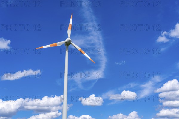 Wind turbine, wind energy plant from the manufacturer Enercon, blue sky with many white clouds,