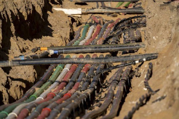 Cables, pipes, next to each other in a construction site, supply lines exposed during construction