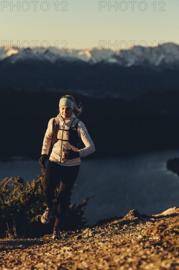 Trail running in autumn on the Jochberg on Lake Walchensee against the wonderful backdrop of the