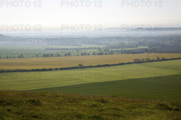 Early morning ground fog lying over fields in the Vale of Pewsey, near Alton Barnes, Wiltshire,