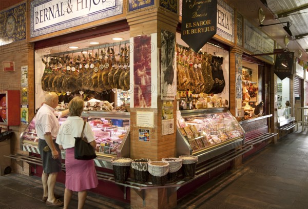 Butcher's stall in historic market building in Triana, Seville, Spain, Europe