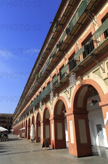 Historic buildings in Plaza de Corredera seventeenth century colonnaded square, Cordoba, Spain,