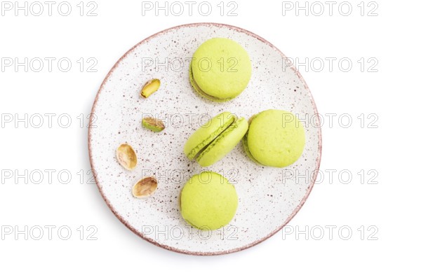Green macarons or macaroons cakes isolated on white background. Top view, close up