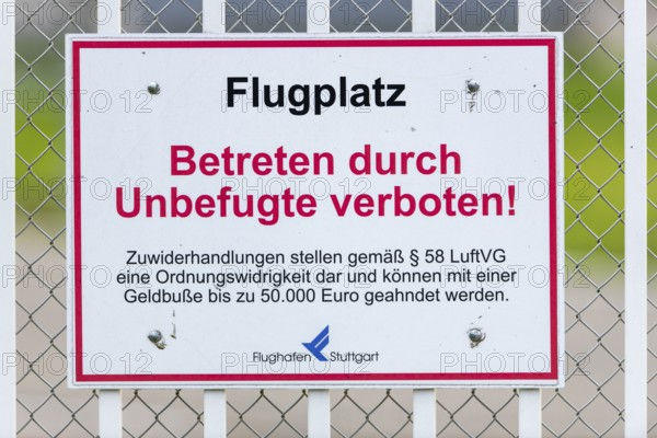 Sign on an airport barrier fence, trespassing by unauthorised persons prohibited, Stuttgart,