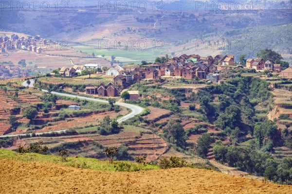 Terraced fields and two stories brick houses in Betsileo rural village in the Ambositra District,