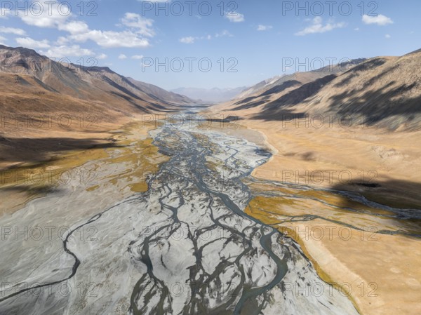Aerial view, Burkhan mountain valley with meandering river, barren dramatic mountain landscape,