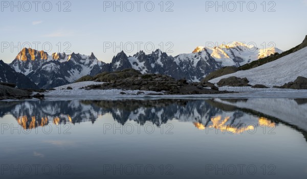 Morning atmosphere, mountain landscape at sunrise, water reflection in Lac Blanc, mountain peak,