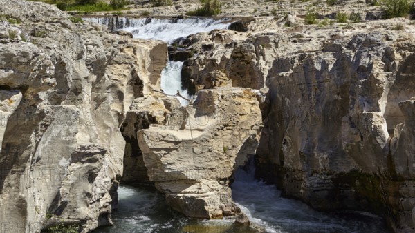 The cascades of Sautadet with limestone cliffs and the river Cèze in La Roque-sur-Cèze, Département