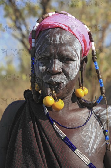 South Ethiopia, in Maco National Park, Mursi tribe, Mursi woman with painted skin and earrings,