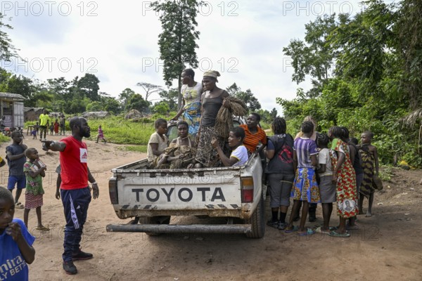 Pygmies of the Baka or BaAka people with their hunting nets on a pick-up truck, Bayanga,
