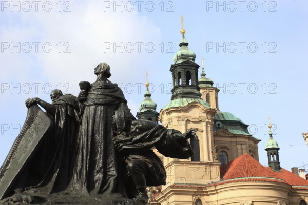 Jan Hus Monument on Old Town Square and the baroque St Nicholas Church, Prague, Czech Republic,