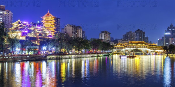 Chengdu Anshun Bridge over Jin River with pagoda at night panorama in Chengdu, China, Asia