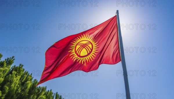 The flag of Kyrgyzstan, Kyrgyzstan, flutters in the wind, isolated against a blue sky, Asia