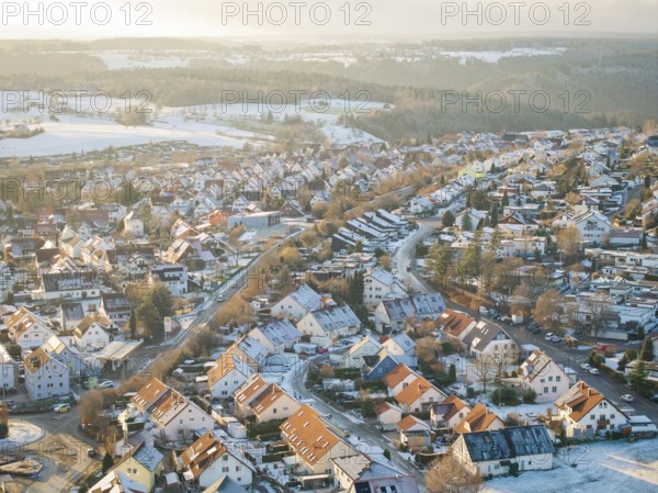 Snow-covered town roofs and winding streets in a wintry landscape, Calw- Stammheim, Black Forest,