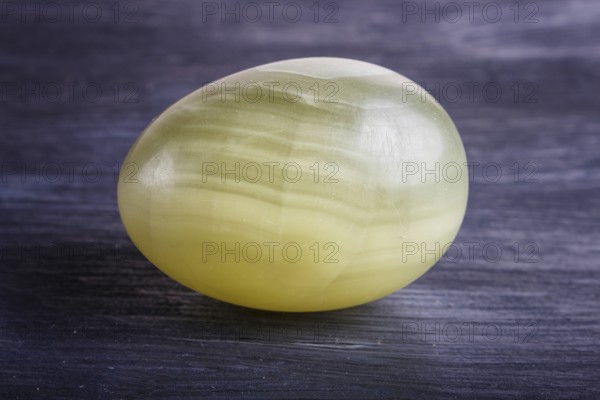 Green onyx egg on a black background, close up