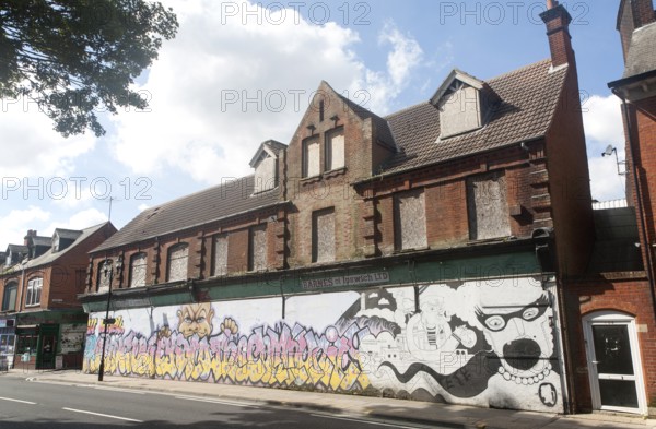 Painted hoarding boards around derelict shop buildings in Upper Orwell Street, Ipswich, Suffolk,