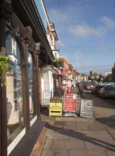 People shopping on historic High Street of Marlborough, Wiltshire, England, UK