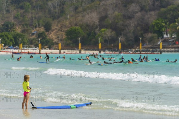 Girl on the beach in a surf school, water sports, beach, sea, ocean, sport, holiday, travel,