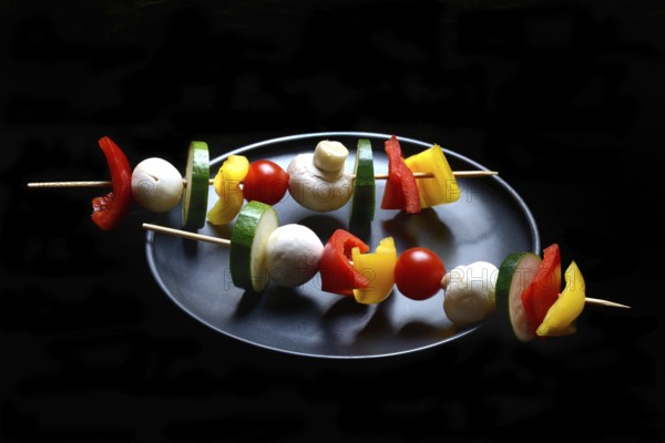 Colourful vegetable skewers on a plate, barbecue skewers