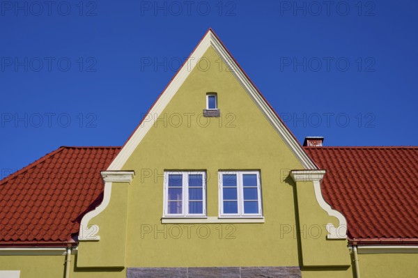 House gable with red tiled roof and white windows against a clear blue sky, Molde, Romsdal, Norway,