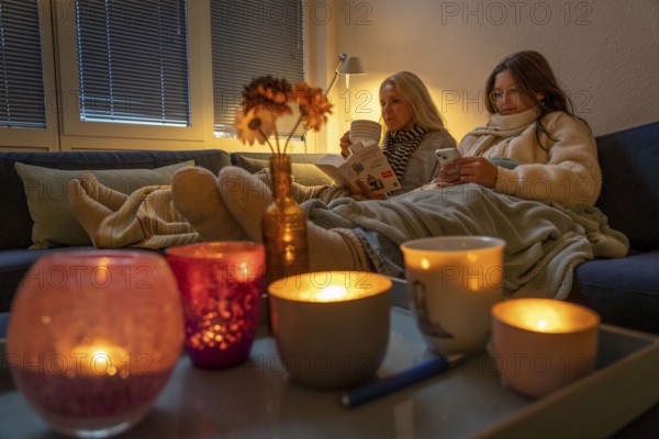Symbolic image energy saving, cold winter, energy crisis, cold flat, mother and daughter lying on