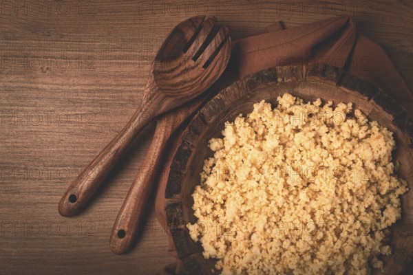 Cooked couscous, in a wooden bowl, top view, no people