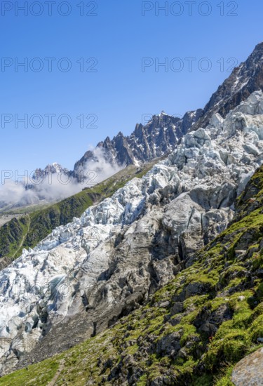 Glacier ice of the Glacier des Bossons, behind pointed mountain peaks, Chamonix, Haute-Savoie,