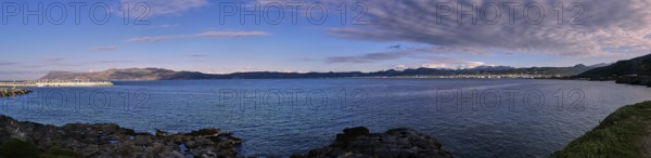 Panoramic view of a coastal landscape with calm sea and cloudy sky in the background, Gulf of