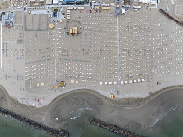 Bathing beach in Rimini. Bathing beach on the Adriatic in bad weather. All deckchairs are free.