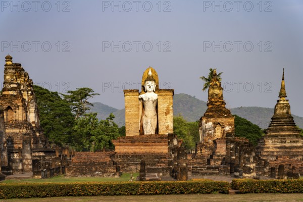 Giant standing Buddha in the Wat Mahathat temple in the UNESCO World Heritage Sukhothai Historical
