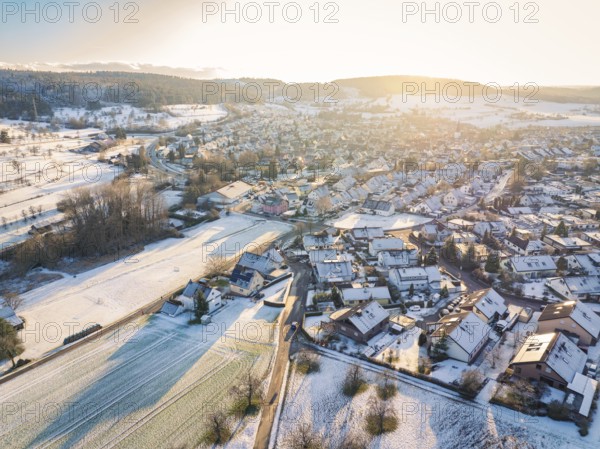 Winter village at dusk with snow-covered roofs and fields in soft light, Calw- Stammheim, Black