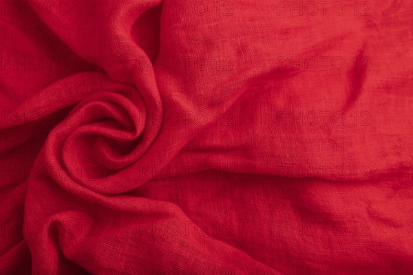 Fragment of red silk tissue. Top view, flat lay, natural textile background and texture. wave