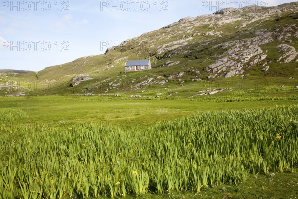 Small boffey building in rocky setting, at Allathasdal, Barra, Outer Hebrides, Scotland, UK