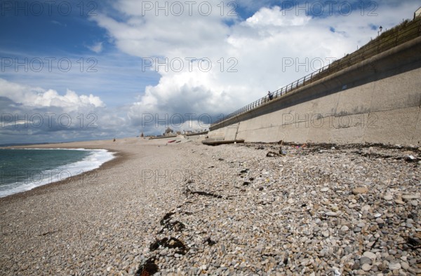 Shingle beach and large sea wall providing coastal defence at Chiswell, Isle of Portland, Dorset,